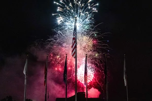 fireworks behind American flag